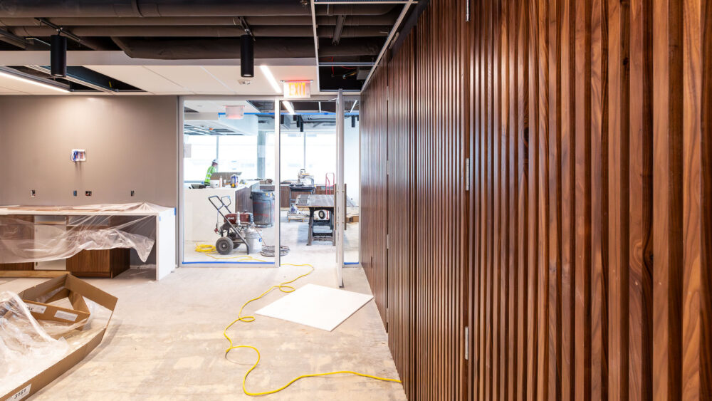 Image of the CFO's office renovation project showing a wall with narrow wood panels.