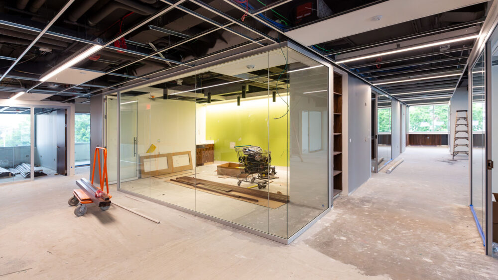 Image of the CFO's office renovation project showing a glassed-in room with a bright green wall.