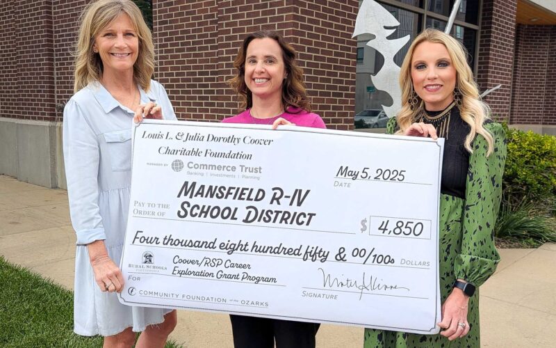 Three women -- Beth Hugs, Ashley Walden and Candice White -- hold an oversized check to the Mansfield R-IV School District for $4,850.