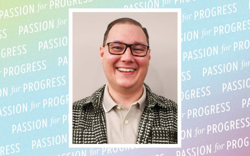 A headshot of Greg Carter, a man with glasses smiling warmly. He is wearing a green checkered jacket over a tan polo shirt. The background is a pastel gradient pattern with the repeating text "PASSION for PROGRESS."