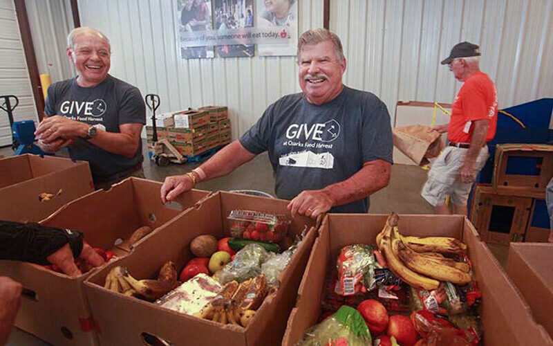 Volunteers distribute food from a Musgrave poverty, hunger, and homelessness grant