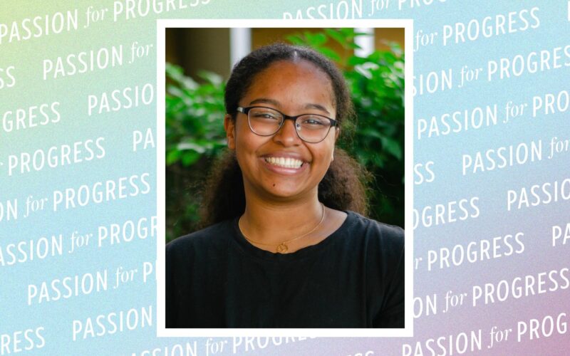 Portrait of Nicole McCain, a woman wearing glasses and a black shirt, framed against a pastel background patterned with the words “Passion for Progress.”