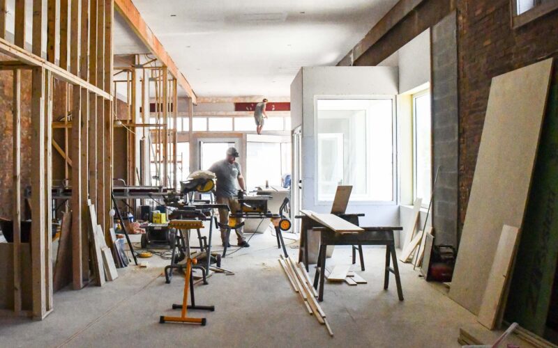 Two men work on the interior of the historic McClellan building in Willow Springs.