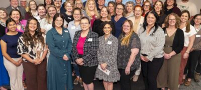 Dozens of people pose indoors in front of an event backdrop featuring logos for Jeannette L. Musgrave Foundation, Community Foundation of the Ozarks and US Bank Private Wealth Management.