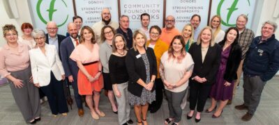 A group of people representing donors and nonprofits celebrate grants presented by the Community Foundation of the Ozarks.