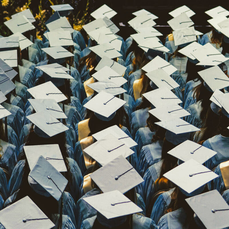 Overhead view of graduates with their caps on